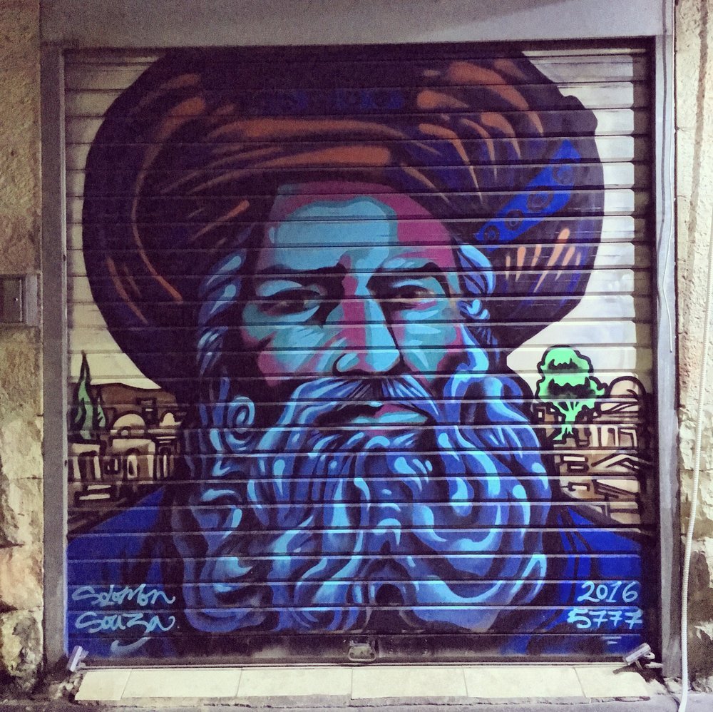 A spray painting of a chasidic man on the door of a shop in the shuk in Jerusalem